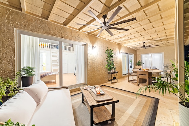 interior space featuring lofted ceiling with beams, ceiling fan, and wood ceiling