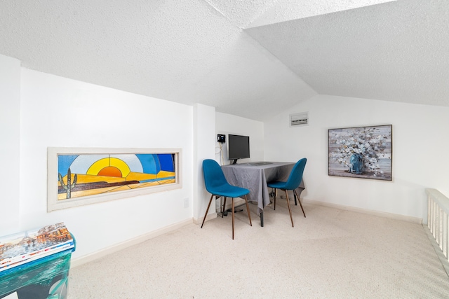 office space featuring a textured ceiling, carpet floors, and vaulted ceiling