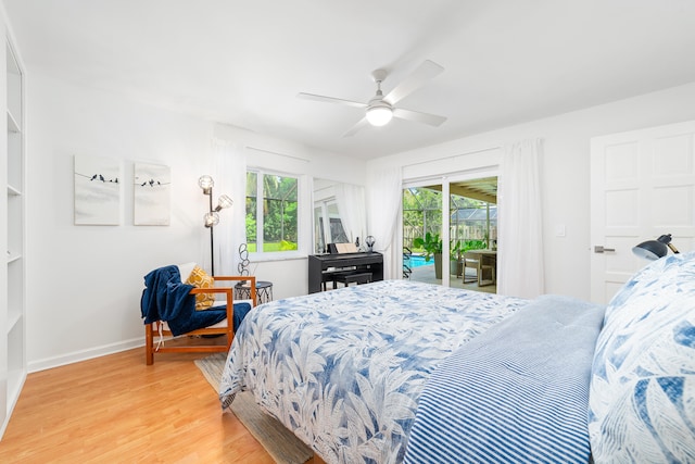 bedroom featuring access to outside, multiple windows, ceiling fan, and light hardwood / wood-style flooring