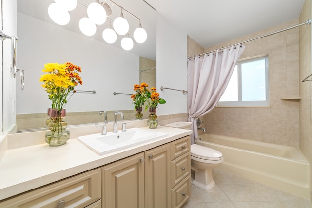 full bathroom featuring tile patterned floors, shower / tub combo with curtain, vanity, and toilet