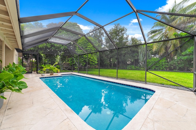 view of pool featuring a lawn, glass enclosure, and a patio