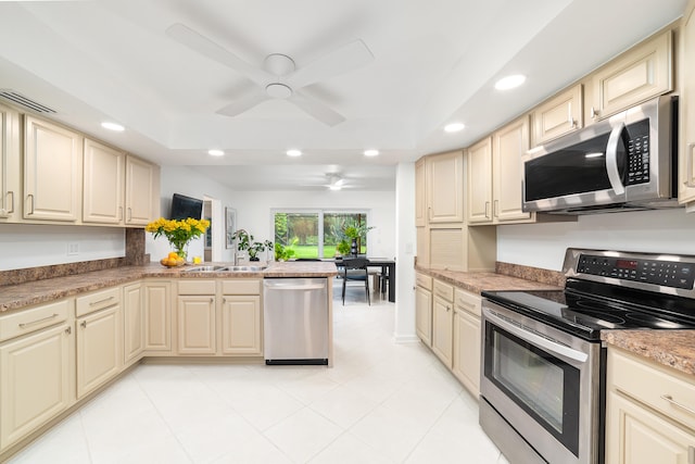 kitchen featuring cream cabinetry, sink, and stainless steel appliances