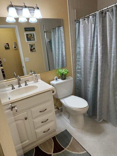 bathroom with vanity, toilet, and curtained shower