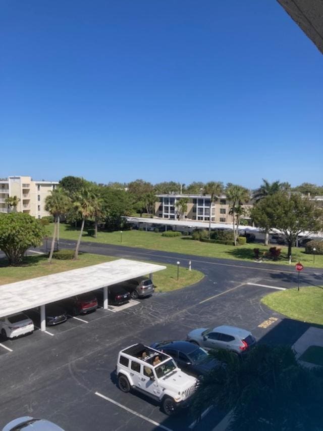 view of parking / parking lot featuring a carport