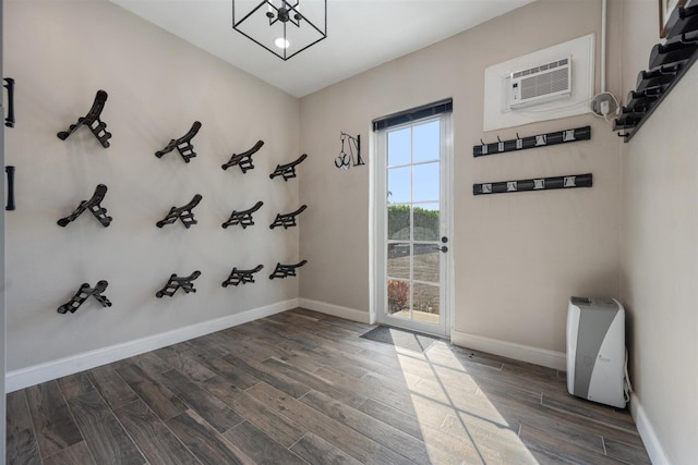 interior space featuring dark wood-type flooring and a wall mounted AC