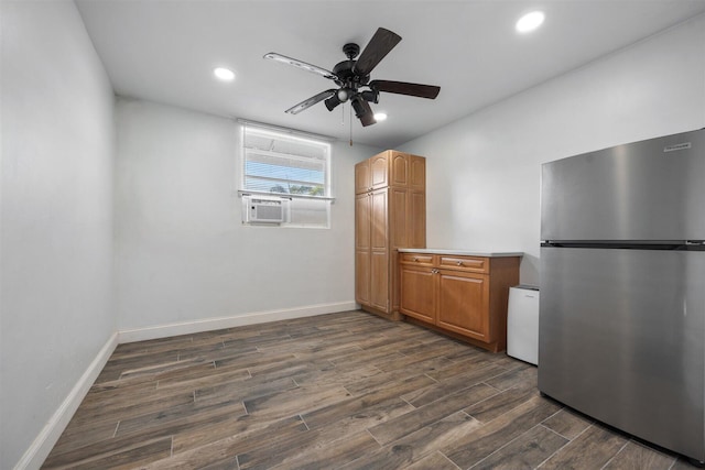 kitchen with dark hardwood / wood-style flooring, cooling unit, ceiling fan, and stainless steel fridge