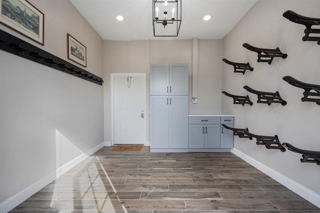 interior space featuring dark wood-type flooring and a chandelier