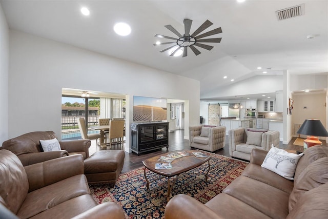 living room with dark wood-type flooring, lofted ceiling, and ceiling fan