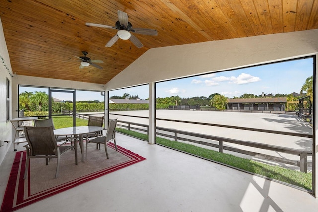 unfurnished sunroom with ceiling fan, wood ceiling, and lofted ceiling