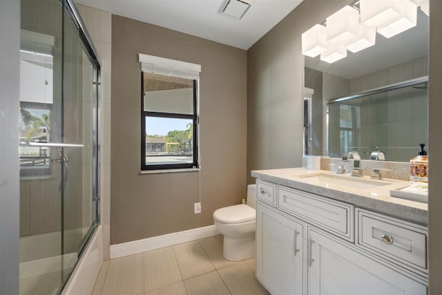 full bathroom with shower / bath combination with glass door, tile patterned floors, vanity, and toilet