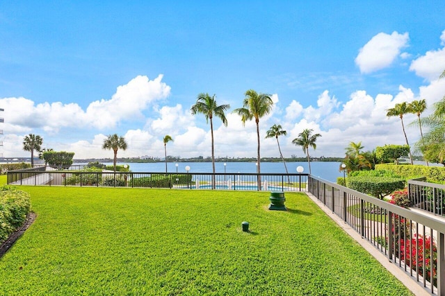 view of yard featuring a water view and fence