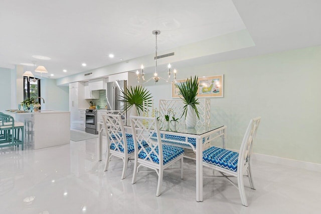 dining room with sink and an inviting chandelier