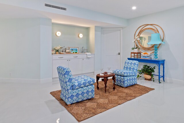 living area with concrete flooring and sink