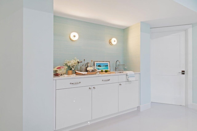 bar featuring white cabinetry and sink