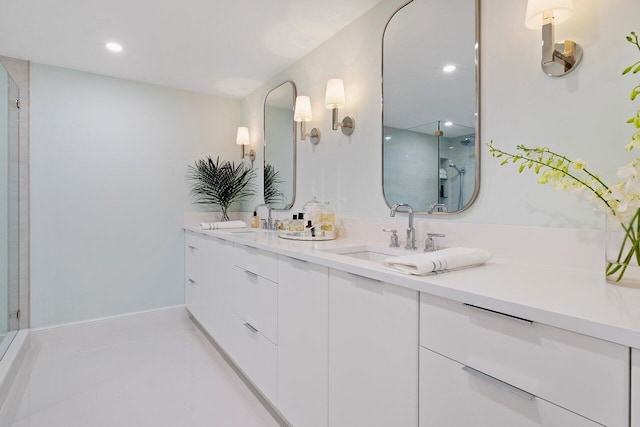 bathroom with double vanity, tile patterned floors, a sink, and a shower with shower door