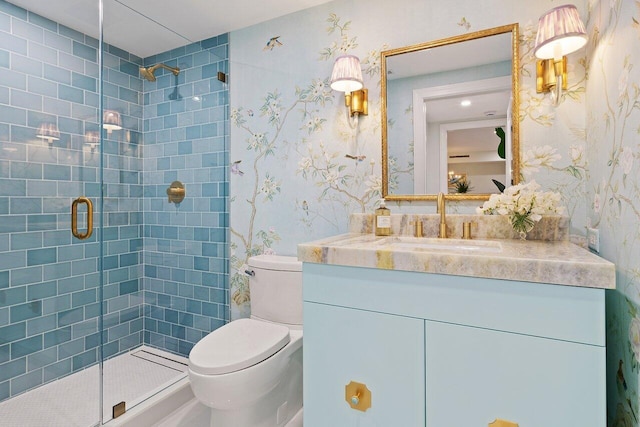 bathroom featuring vanity, toilet, and a shower with door