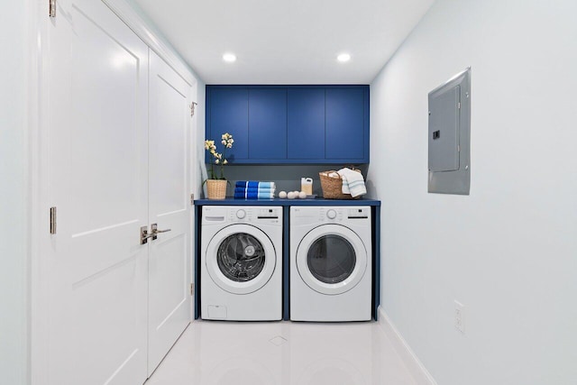 laundry area with cabinets, electric panel, and washer and clothes dryer