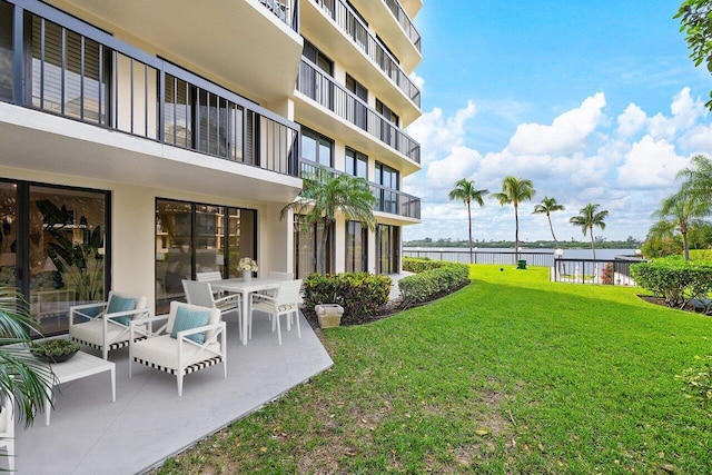 view of yard with a patio and a water view