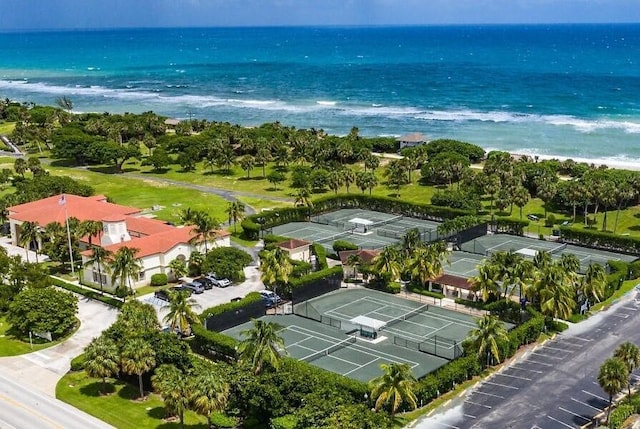 bird's eye view with a water view and a beach view