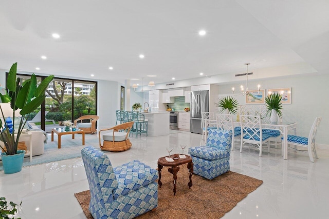 living area with recessed lighting, visible vents, and a notable chandelier