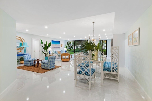 living room featuring an inviting chandelier and a wall of windows