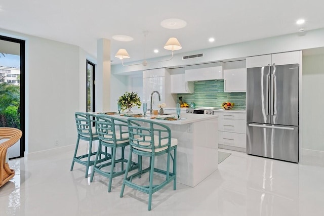 kitchen featuring visible vents, appliances with stainless steel finishes, modern cabinets, and white cabinetry