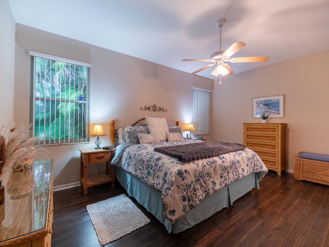 bedroom with ceiling fan and dark hardwood / wood-style floors