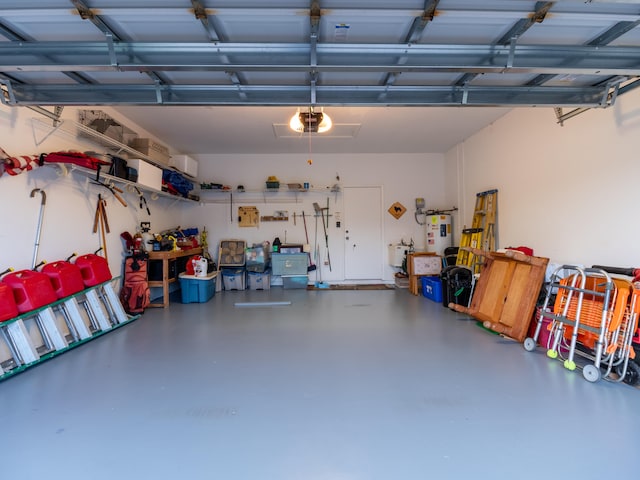 garage with electric water heater and a garage door opener