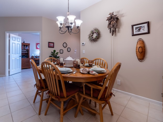 tiled dining area with an inviting chandelier