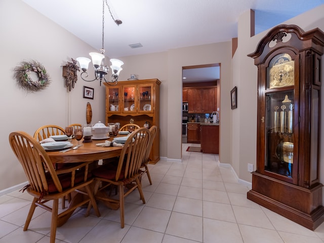 dining area featuring sink, a chandelier, and light tile patterned flooring