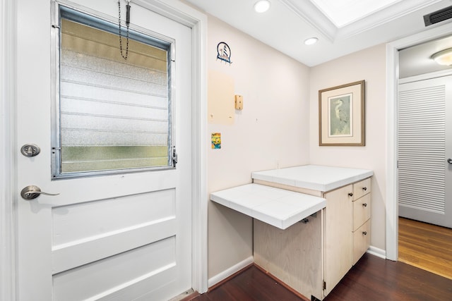 doorway to outside with recessed lighting, dark wood-type flooring, and baseboards