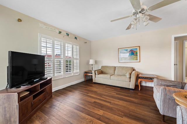 living room with dark wood-style floors, ceiling fan, and baseboards