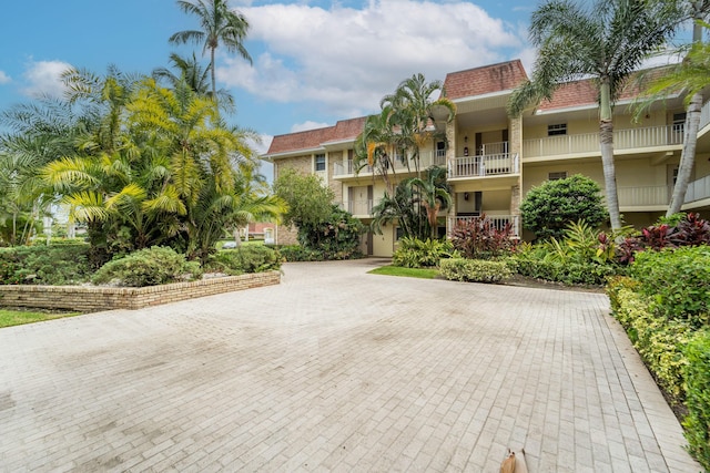 view of building exterior with decorative driveway