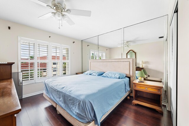 bedroom with ceiling fan and dark hardwood / wood-style flooring