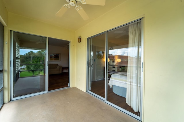 unfurnished sunroom with ceiling fan
