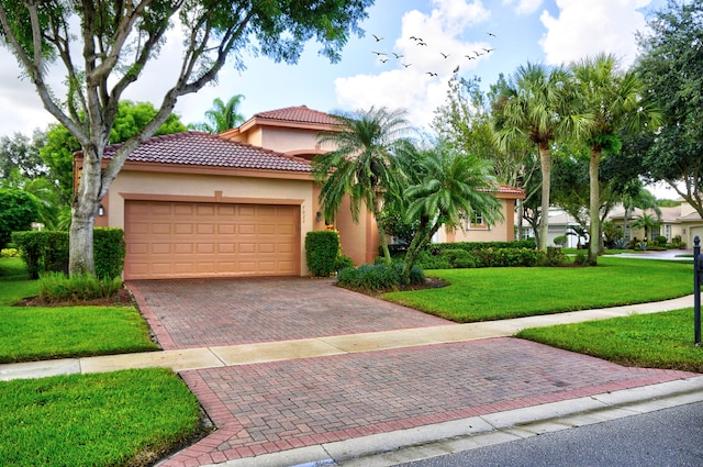 mediterranean / spanish-style house with a garage and a front yard