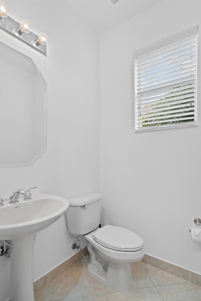 bathroom with tile patterned flooring, toilet, and sink