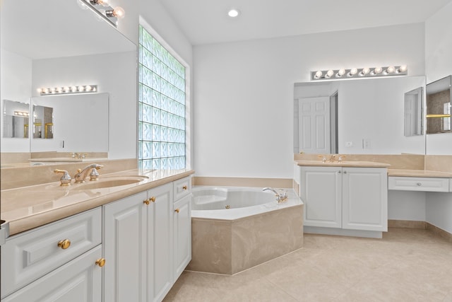 bathroom featuring tile patterned floors, vanity, and tiled bath