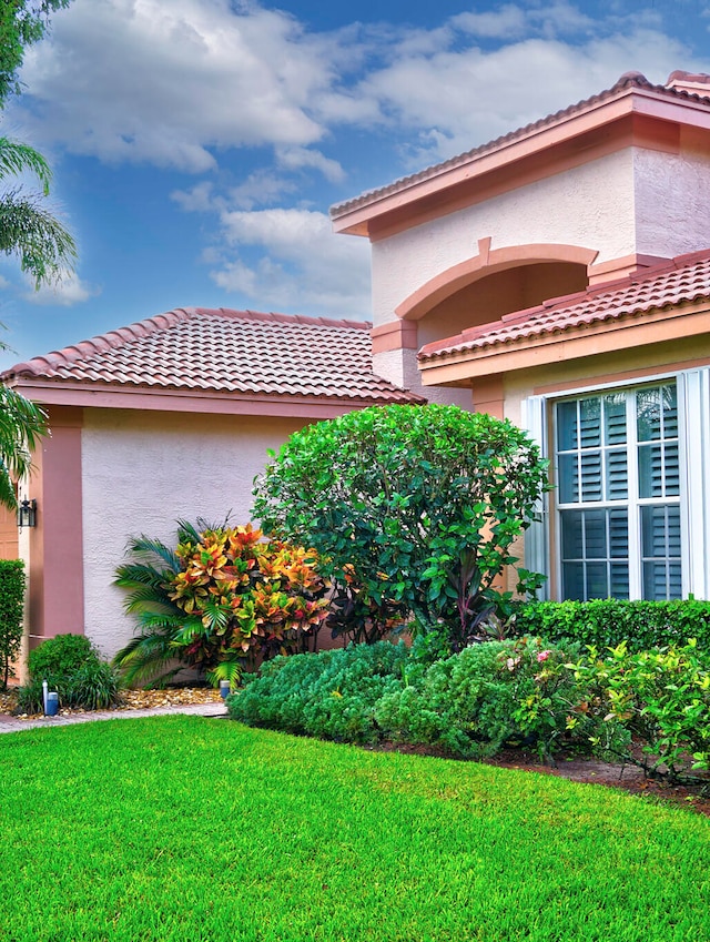 view of side of home featuring a lawn