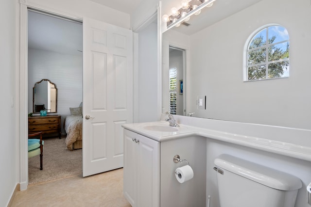 bathroom featuring tile patterned floors, vanity, and toilet