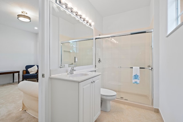 bathroom featuring toilet, vanity, tile patterned floors, and an enclosed shower