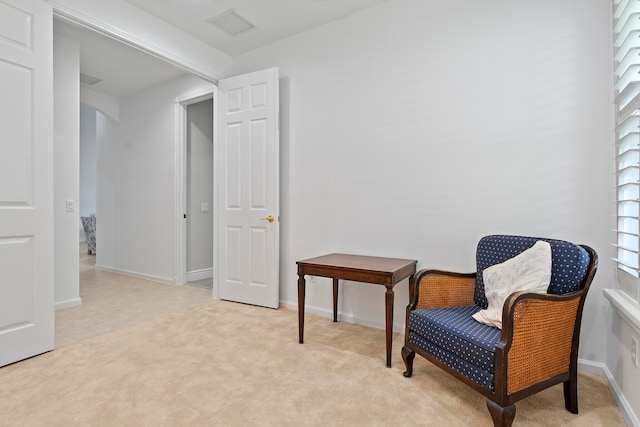 sitting room featuring plenty of natural light and light colored carpet