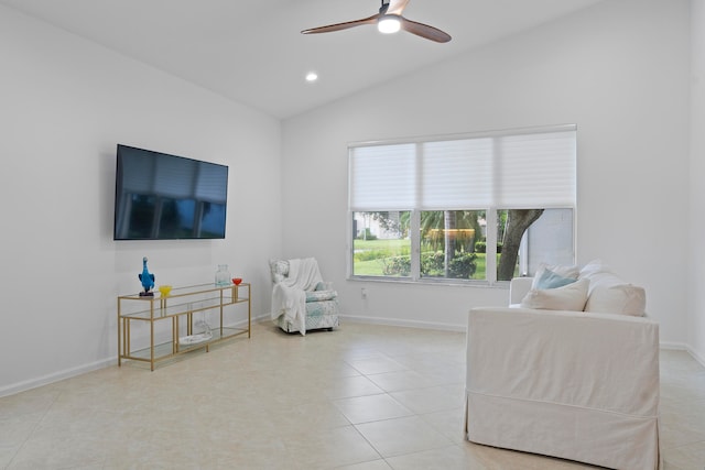 sitting room with light tile patterned floors, vaulted ceiling, and ceiling fan