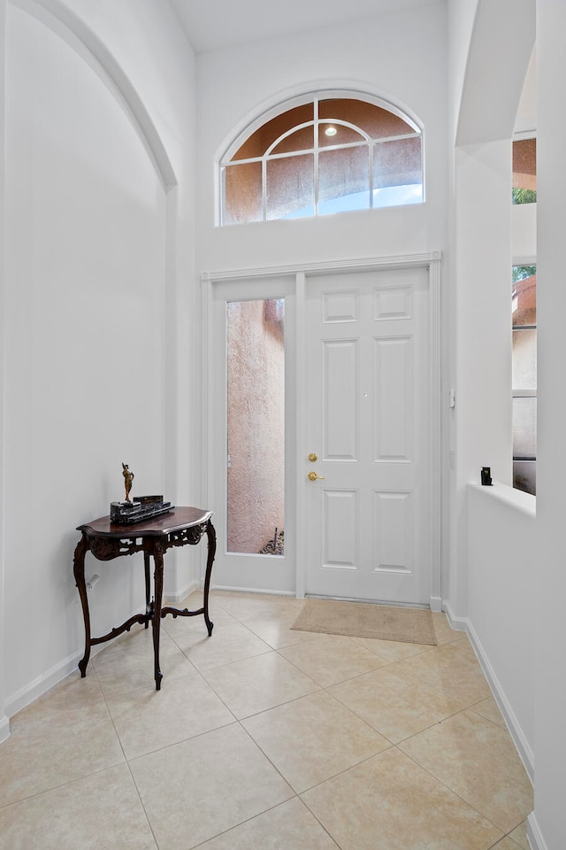 foyer featuring a high ceiling and light tile patterned floors