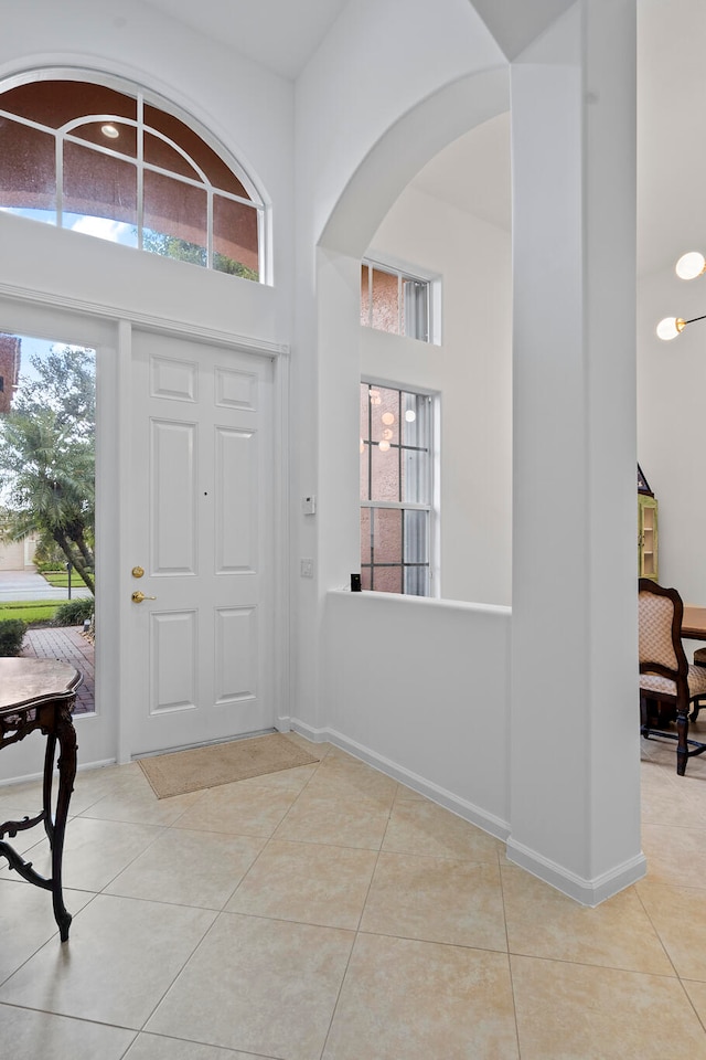 tiled entrance foyer featuring a high ceiling