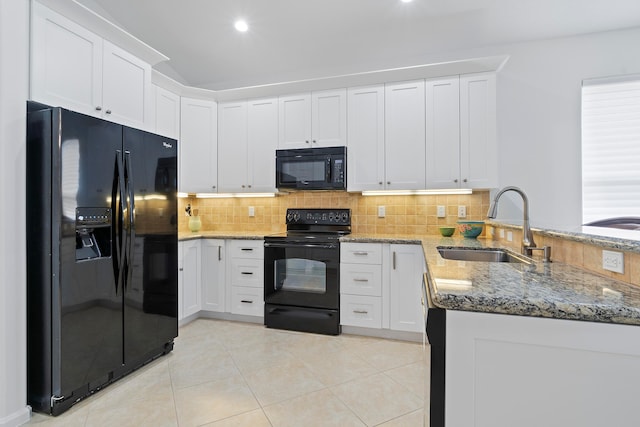 kitchen featuring kitchen peninsula, white cabinets, and black appliances