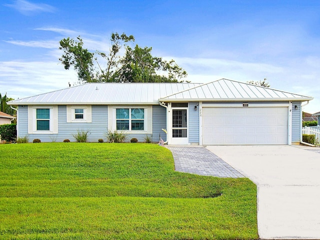 single story home featuring a garage and a front lawn