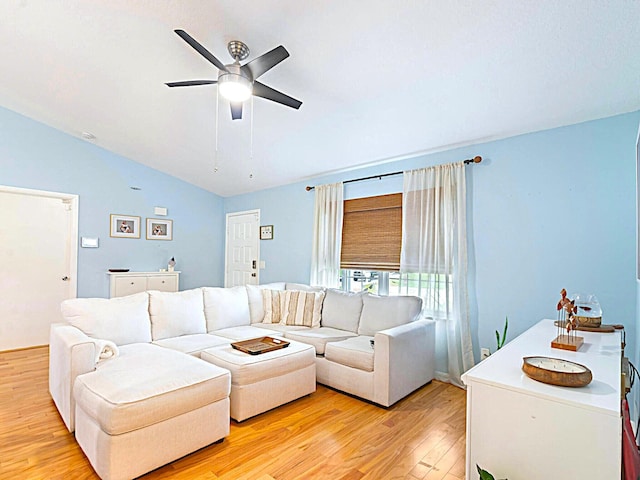 living room featuring vaulted ceiling, ceiling fan, and light hardwood / wood-style floors