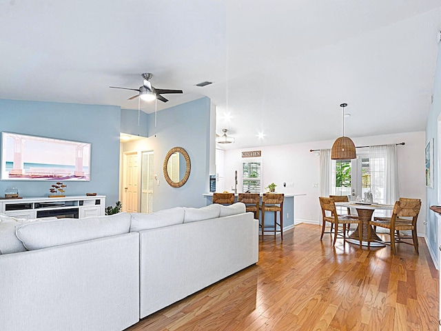 living room with wood-type flooring and ceiling fan