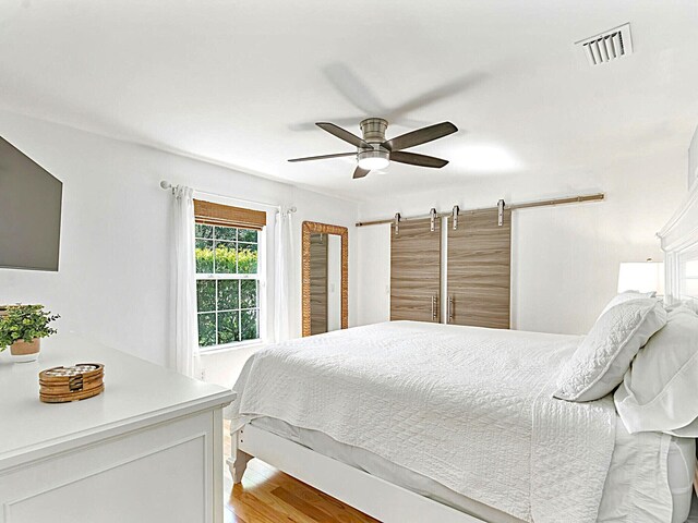 222 SW Starfish Ave, Port Saint Lucie, FL 34984 - bedroom with a ceiling fan and wood finished floors
